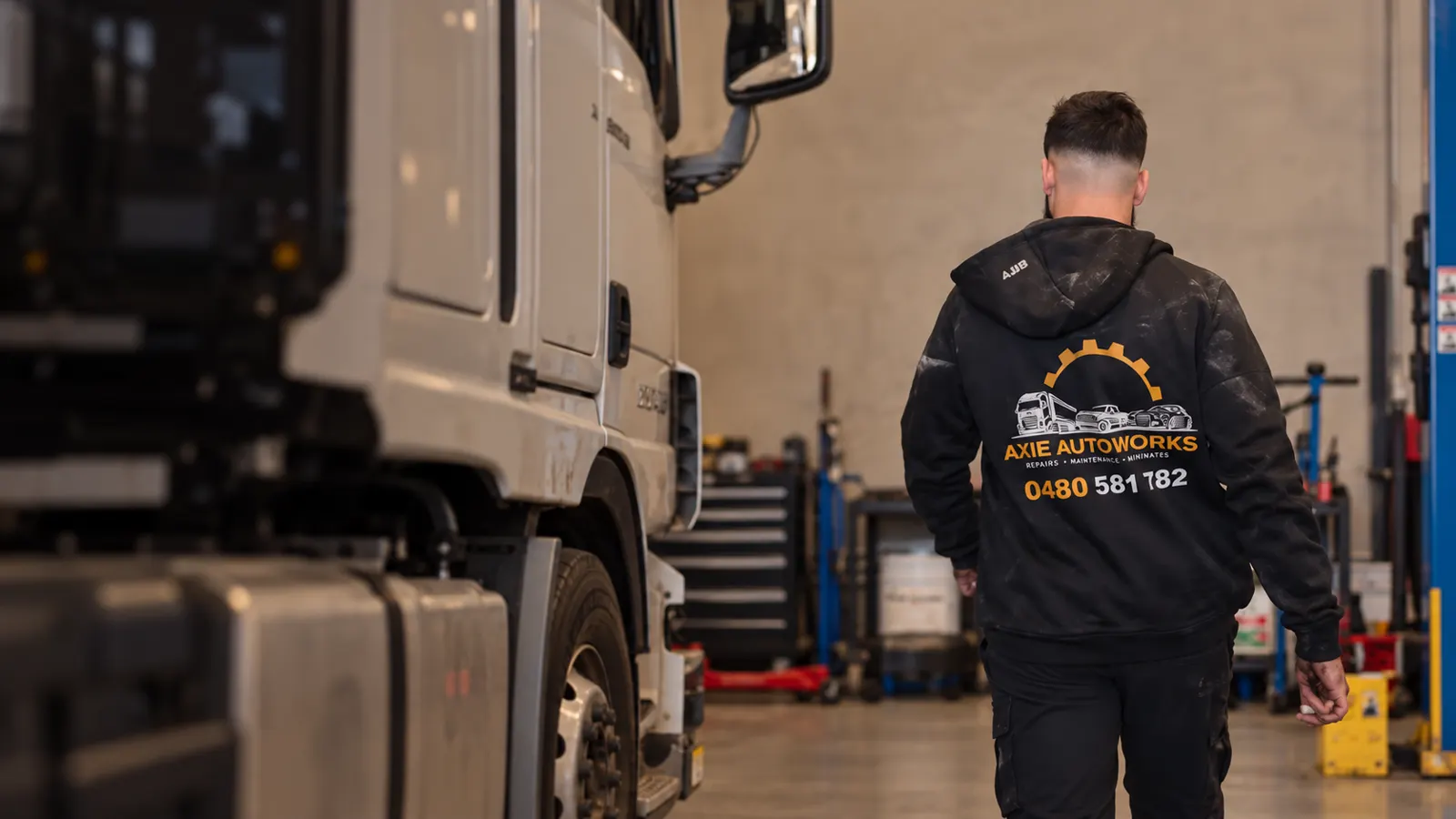 Axie Autoworks team member beside a truck in the workshop